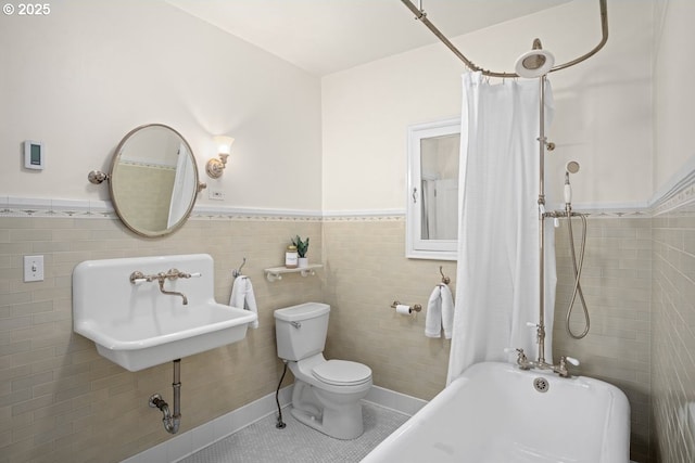 1314 SE 55th Ave, Portland, OR 97215 - full bathroom featuring a wainscoted wall, a sink, tile walls, toilet, and tile patterned floors