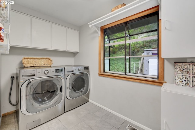 2002 Kimberly Dr, Eugene, OR 97405 - laundry area with cabinet space, baseboards, independent washer and dryer, and light tile patterned floors
