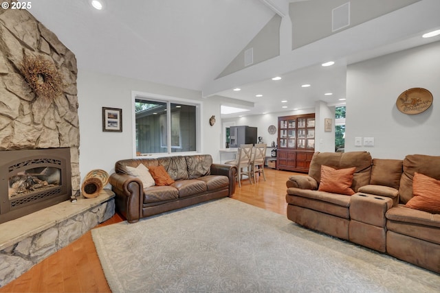 2002 Kimberly Dr, Eugene, OR 97405 - living area featuring wood finished floors, a fireplace, recessed lighting, healthy amount of natural light, and high vaulted ceiling