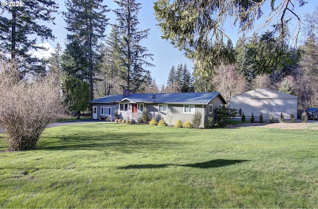 ranch-style home featuring a front yard, a chimney, and metal roof