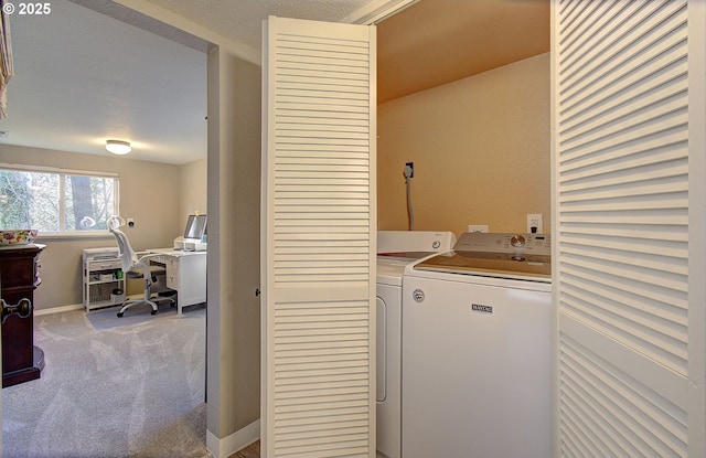 washroom with baseboards, carpet floors, laundry area, and washing machine and clothes dryer