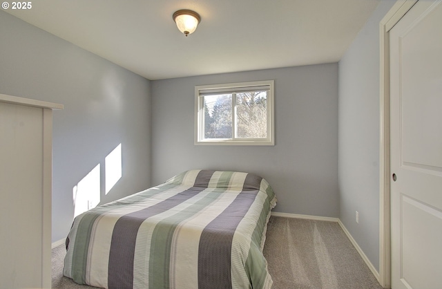 carpeted bedroom with baseboards