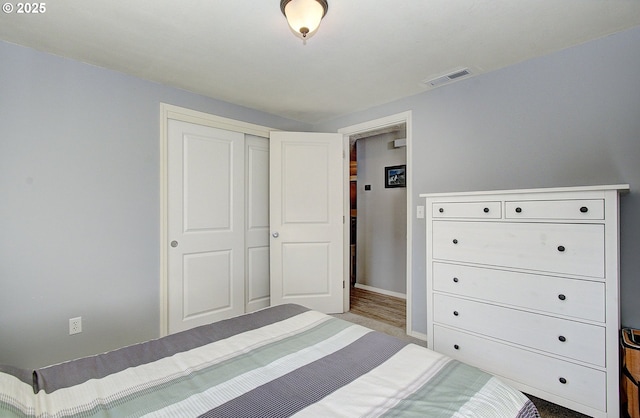 unfurnished bedroom featuring a closet, visible vents, and baseboards