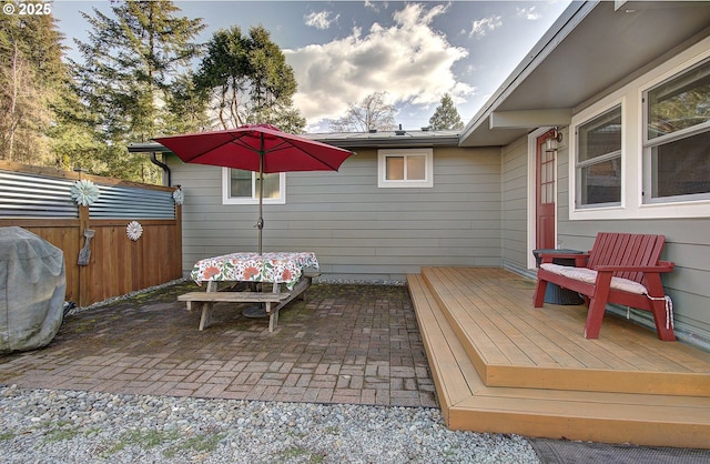 view of patio / terrace featuring a deck and fence