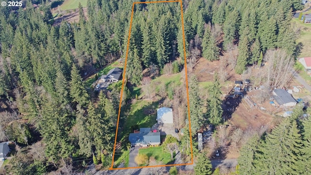 birds eye view of property with a wooded view