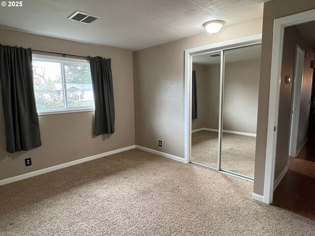 unfurnished bedroom with a closet and carpet