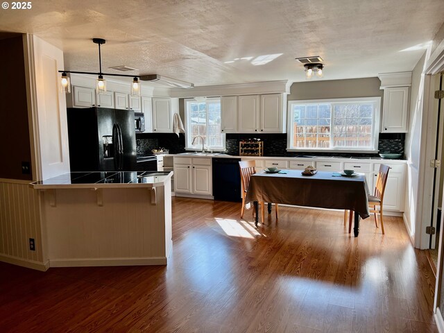 unfurnished living room with dark colored carpet, sink, and a fireplace