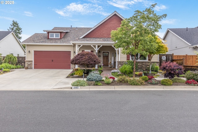 3461 Sterling Woods Dr, Eugene, OR 97408 - craftsman-style house featuring stone siding, a garage, driveway, roof with shingles, and a porch