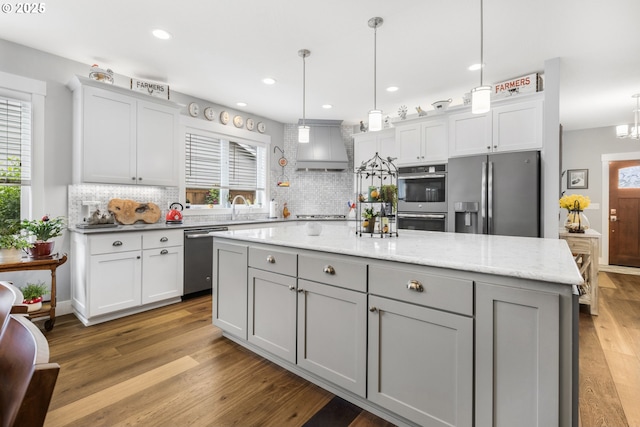 3461 Sterling Woods Dr, Eugene, OR 97408 - kitchen with appliances with stainless steel finishes, custom exhaust hood, backsplash, wood finished floors, and recessed lighting