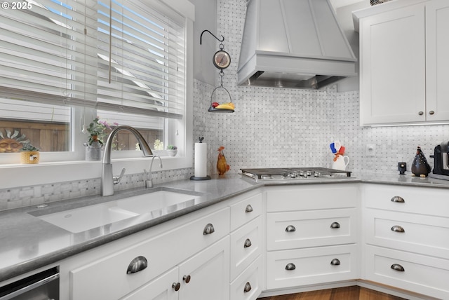 3461 Sterling Woods Dr, Eugene, OR 97408 - kitchen featuring custom range hood, stainless steel gas cooktop, white cabinets, and backsplash