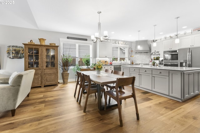 3461 Sterling Woods Dr, Eugene, OR 97408 - dining room with a chandelier, light wood-style floors, and recessed lighting