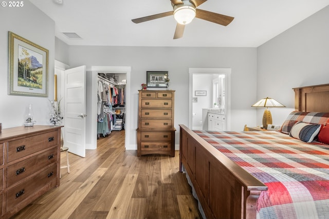 3461 Sterling Woods Dr, Eugene, OR 97408 - bedroom featuring a spacious closet, wood finished floors, a closet, ensuite bath, and ceiling fan