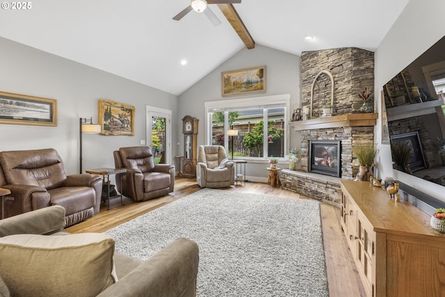 3461 Sterling Woods Dr, Eugene, OR 97408 - living room with a stone fireplace, beamed ceiling, wood finished floors, ceiling fan, and high vaulted ceiling