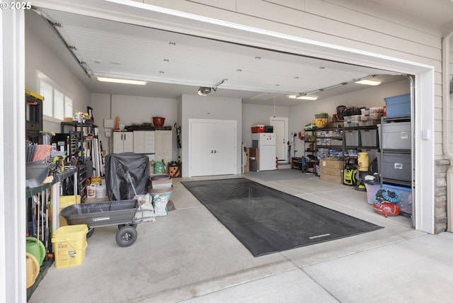 3461 Sterling Woods Dr, Eugene, OR 97408 - garage featuring freestanding refrigerator and a garage door opener