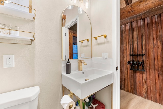 bathroom featuring hardwood / wood-style flooring and toilet