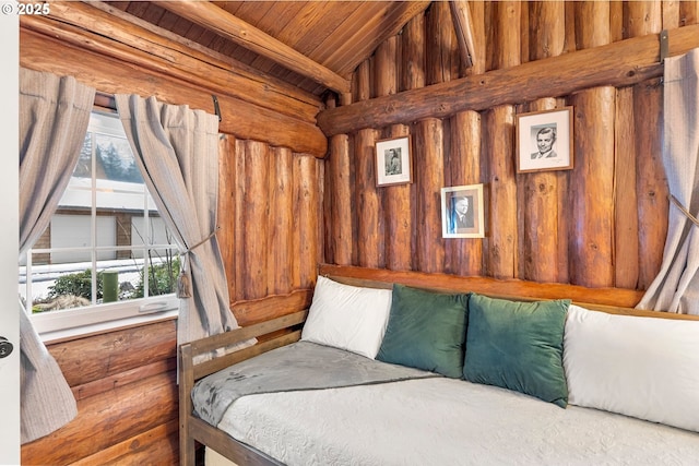 bedroom with vaulted ceiling, wood ceiling, and wood walls