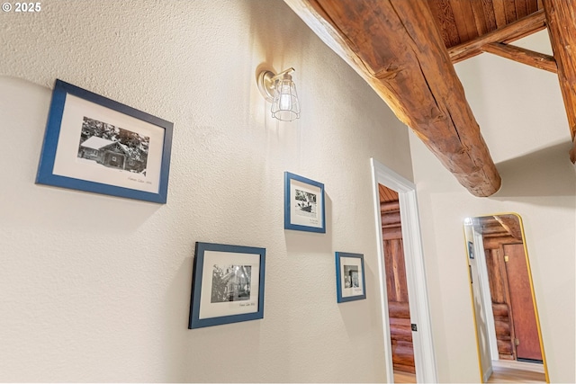 hall featuring beamed ceiling