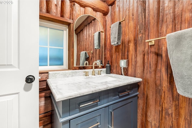 bathroom featuring vanity and wooden walls