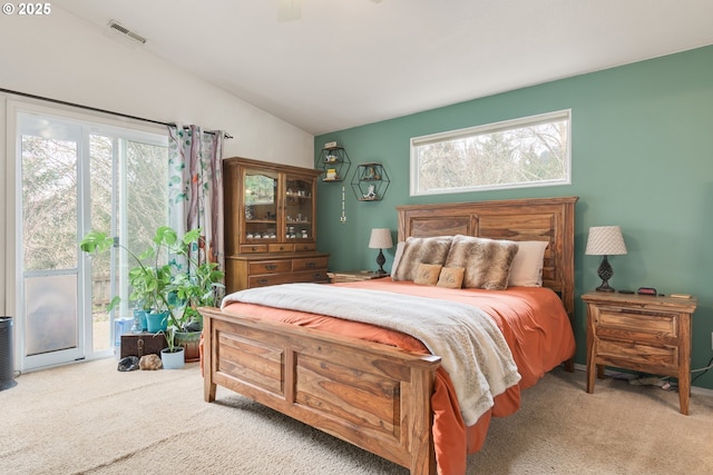 carpeted bedroom with visible vents, lofted ceiling, ceiling fan, and access to outside