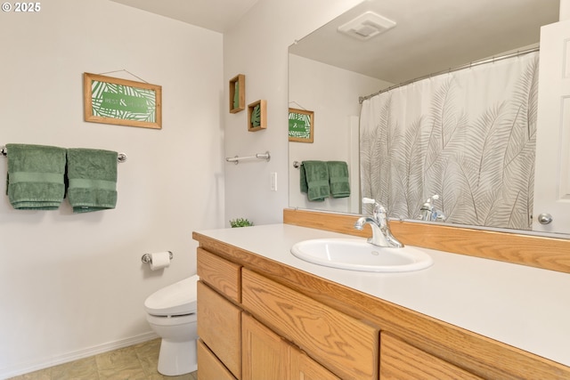 bathroom with vanity, toilet, and visible vents