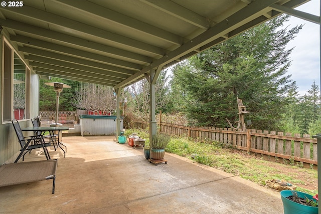 view of patio / terrace featuring a hot tub and a fenced backyard