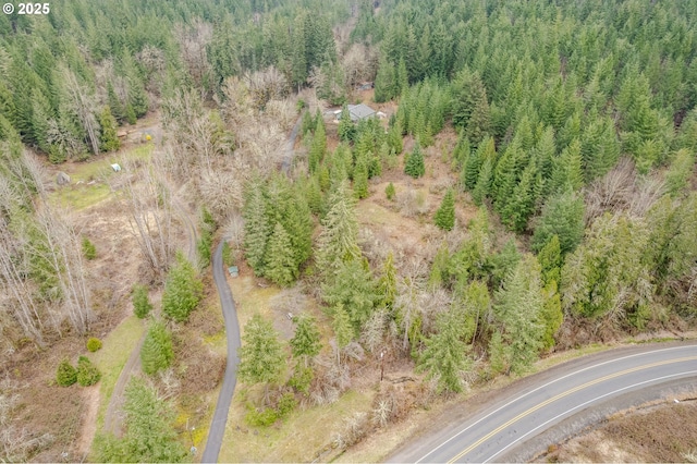 drone / aerial view with a wooded view