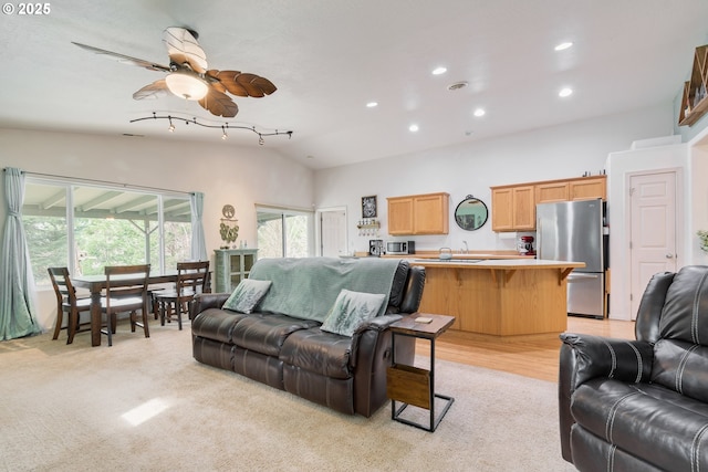 living area featuring light carpet, recessed lighting, a ceiling fan, and vaulted ceiling