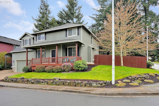 traditional-style house featuring a garage, a porch, a front yard, fence, and driveway