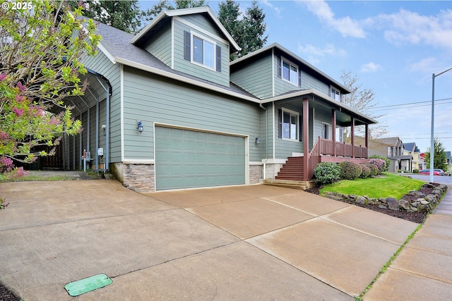 view of front of house featuring roof with shingles, driveway, stone siding, an attached garage, and a porch