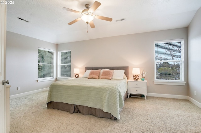 bedroom with light carpet, baseboards, and visible vents