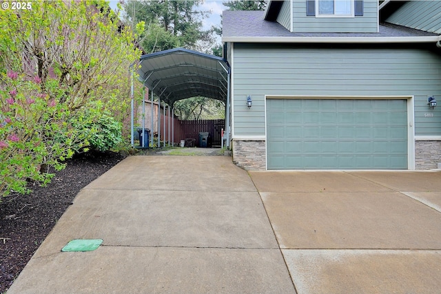 view of side of home featuring a carport, concrete driveway, a garage, and stone siding