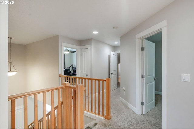 corridor featuring carpet flooring, recessed lighting, an upstairs landing, and baseboards