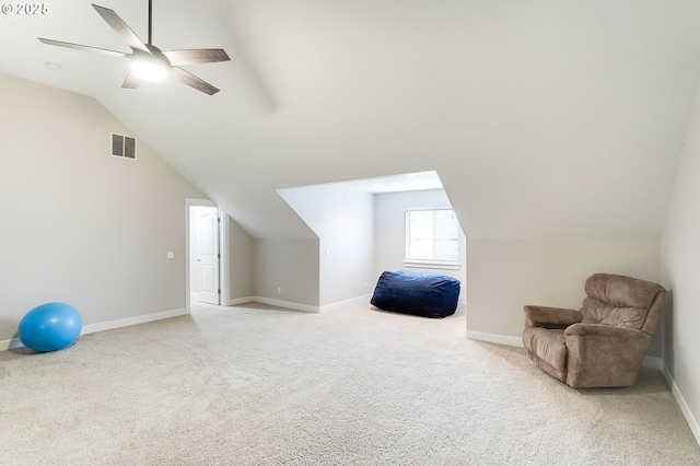 interior space with visible vents, a ceiling fan, carpet floors, and lofted ceiling