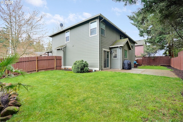 back of property featuring a fenced backyard, a patio, and a lawn