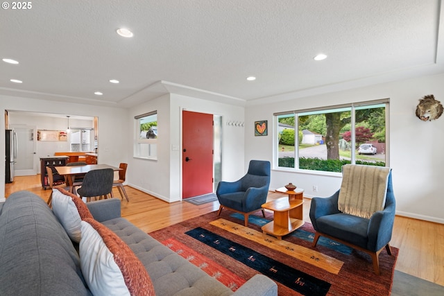 9004 SW 36th Ave, Portland, OR 97219 - living room featuring light wood-style floors, a textured ceiling, and recessed lighting