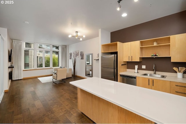 kitchen with dark wood-style floors, stainless steel appliances, light countertops, open shelves, and a sink