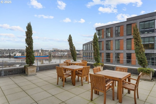 view of patio featuring outdoor dining area and a water view