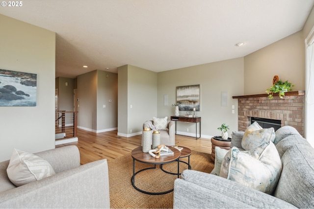 15745 SE Bybee Dr, Portland, OR 97236 - living room featuring wood finished floors, baseboards, recessed lighting, and a brick fireplace
