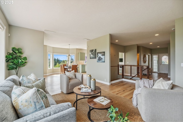 15745 SE Bybee Dr, Portland, OR 97236 - living room with light wood finished floors, plenty of natural light, baseboards, and recessed lighting