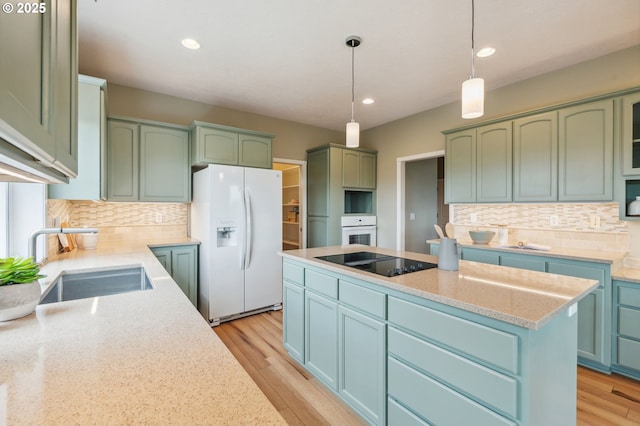 15745 SE Bybee Dr, Portland, OR 97236 - kitchen with white appliances, a sink, green cabinets, backsplash, and recessed lighting