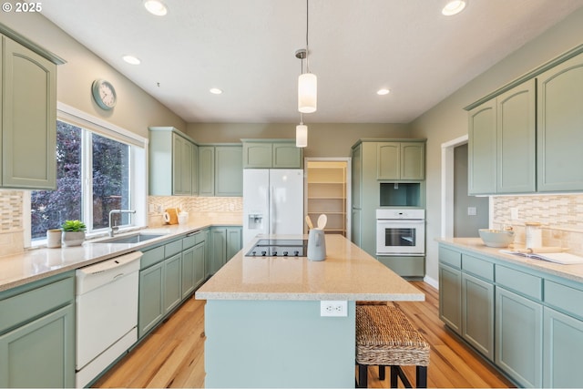 15745 SE Bybee Dr, Portland, OR 97236 - kitchen with white appliances, green cabinetry, recessed lighting, decorative backsplash, and a sink