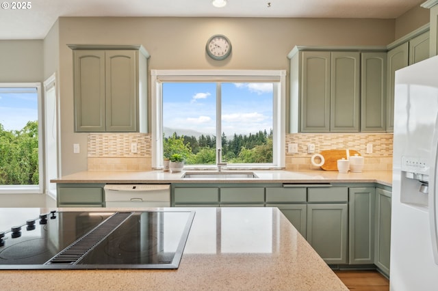 15745 SE Bybee Dr, Portland, OR 97236 - kitchen with green cabinetry, white appliances, a sink, decorative backsplash, and recessed lighting