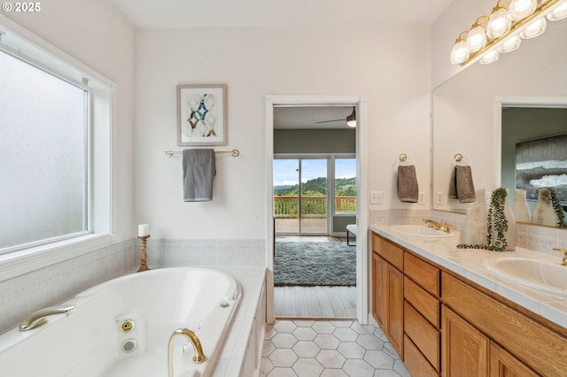 15745 SE Bybee Dr, Portland, OR 97236 - bathroom with double vanity, a tub with jets, and tile patterned floors