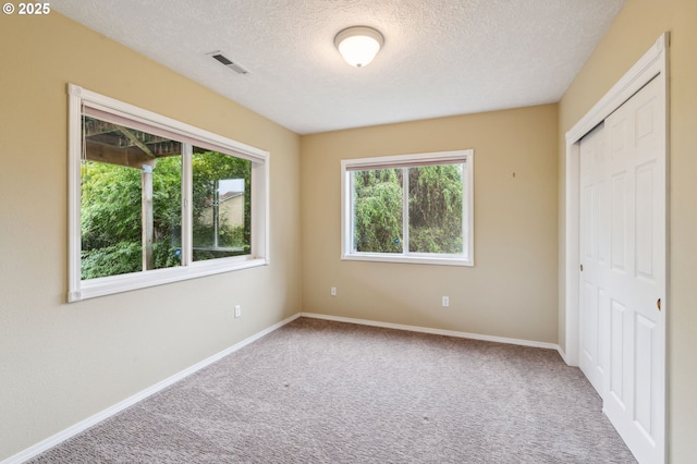15745 SE Bybee Dr, Portland, OR 97236 - unfurnished bedroom featuring a textured ceiling, carpet flooring, a closet, and baseboards