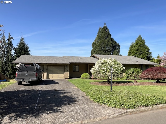 single story home featuring an attached garage, asphalt driveway, and a front lawn