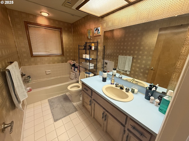full bathroom featuring tile patterned floors, a bathtub, toilet, vanity, and wallpapered walls