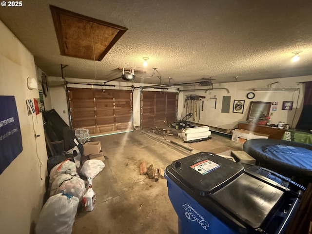 garage with a garage door opener and electric panel