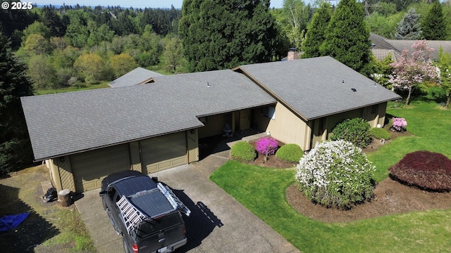 view from above of property featuring a heavily wooded area