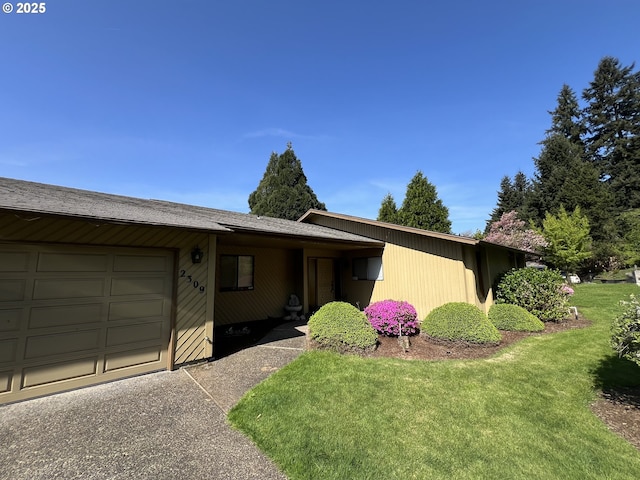 ranch-style home featuring an attached garage and a front lawn