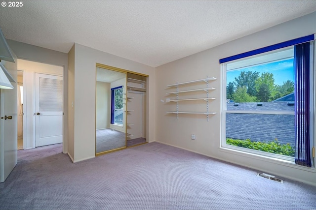12960 SW 5th St, Beaverton, OR 97005 - unfurnished bedroom featuring carpet flooring, a textured ceiling, and a closet